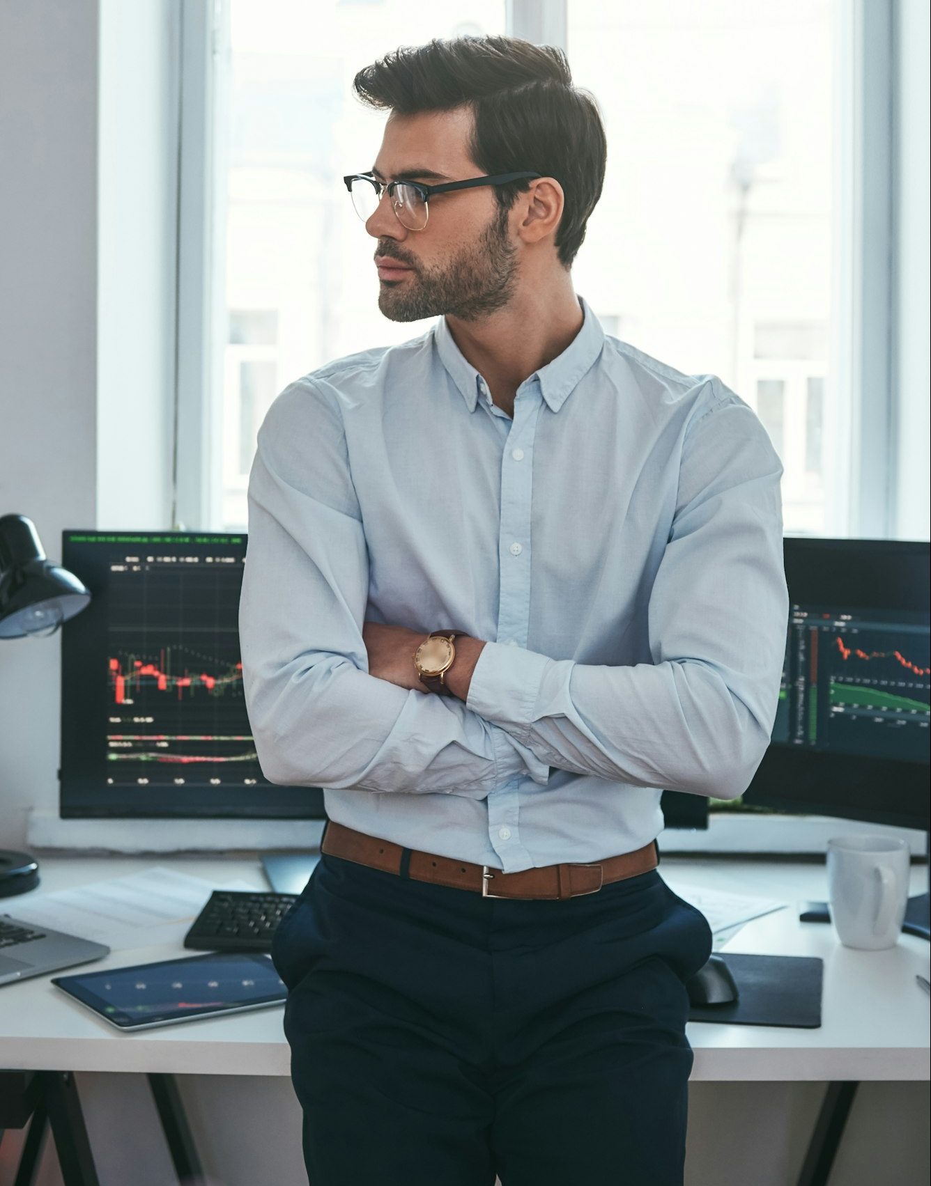 Young and smart. Vertical photo of confident businessman or trader in formal clothes and eyeglasses